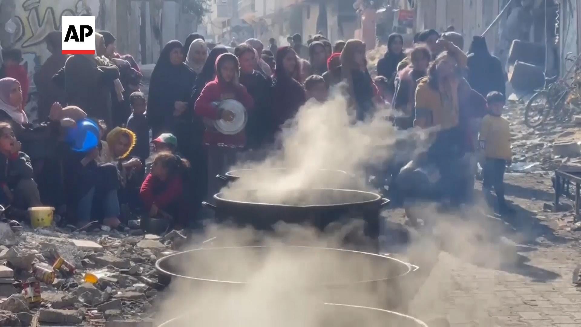 “Hungry Crowds Form at Street Kitchen in Northern Gaza as U.S. Military Builds Floating Dock for Aid Distribution”